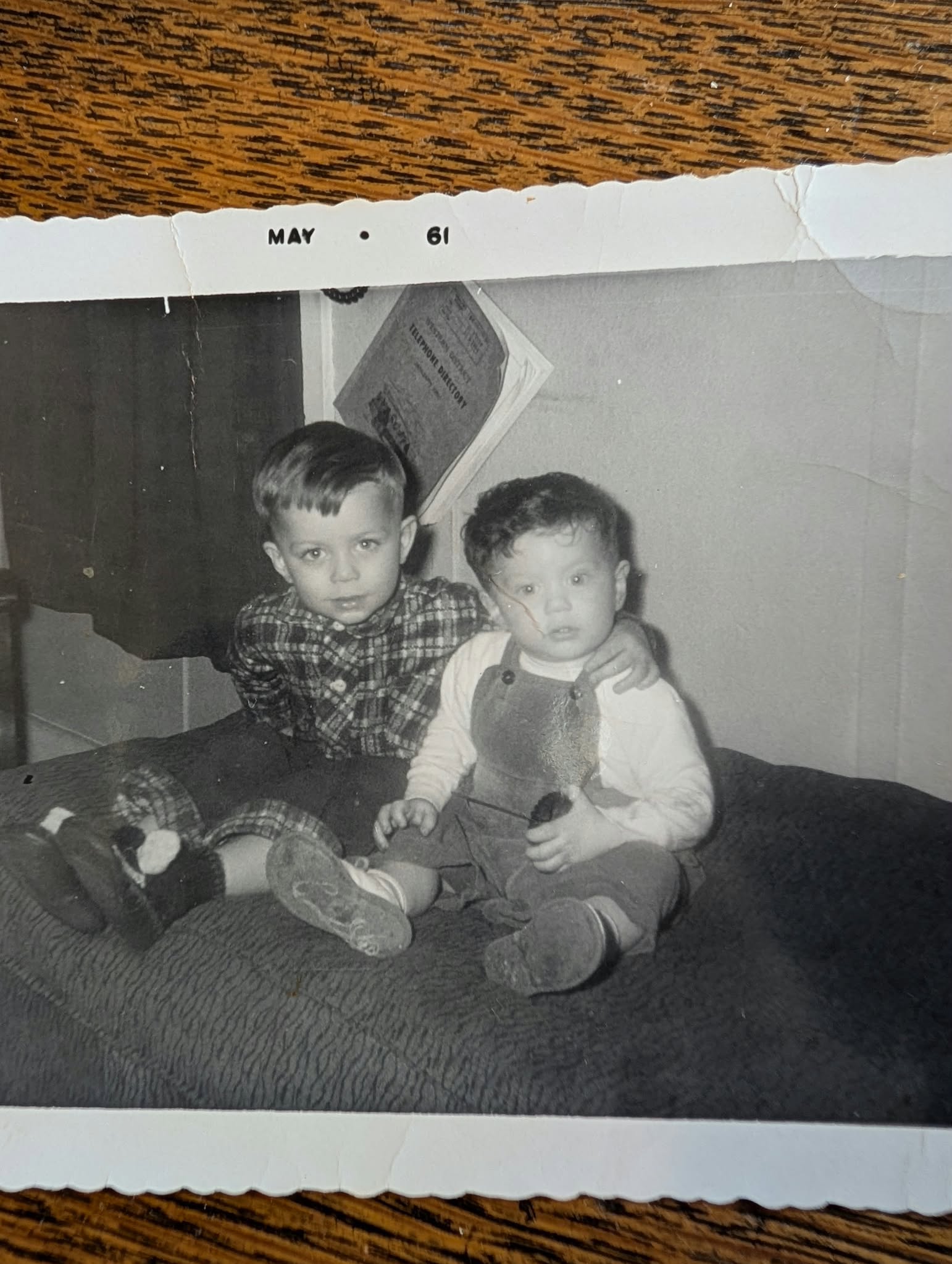 Photograph of a worn black-and-white print showing two children