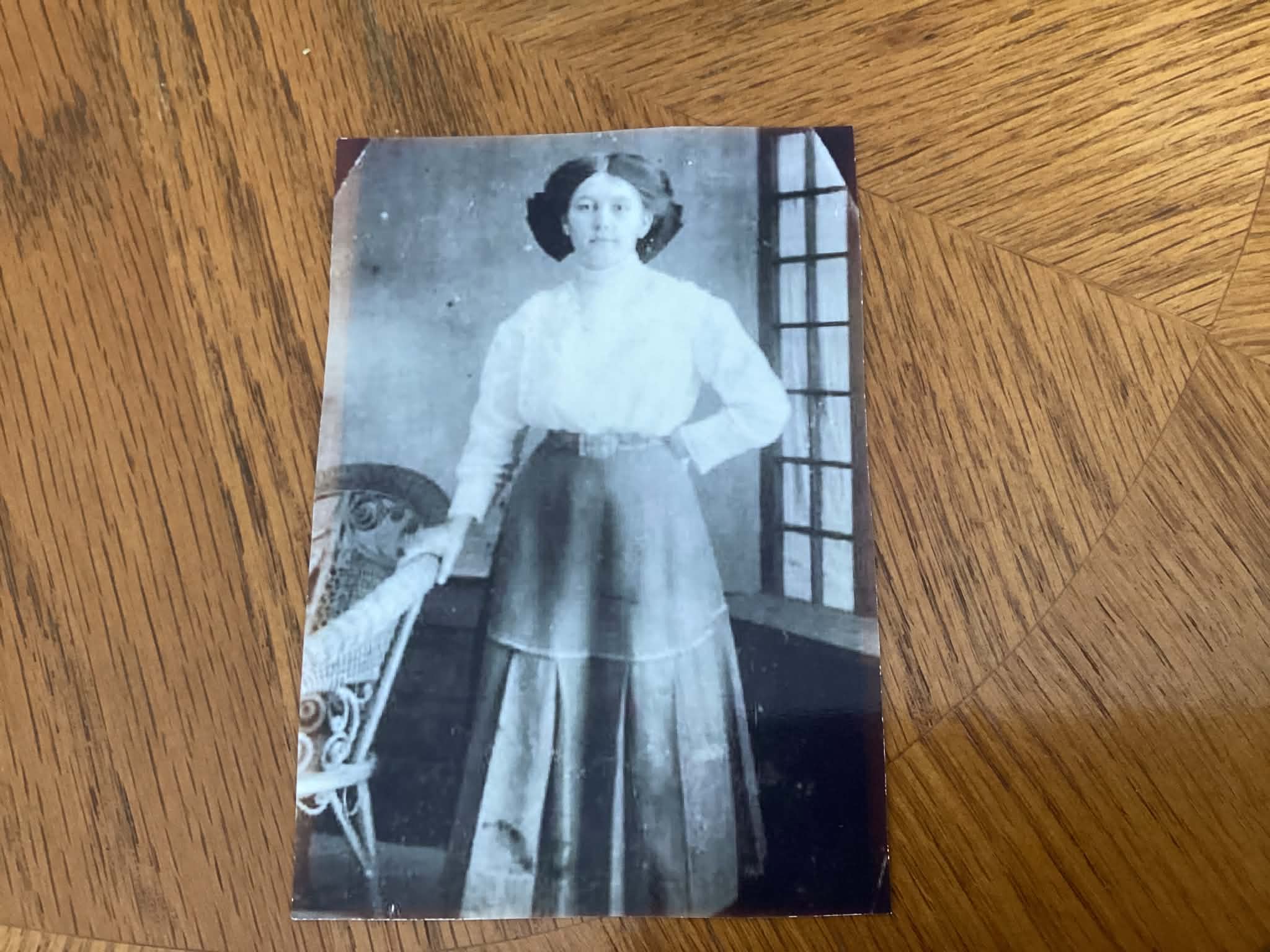 Before: Woman standing beside a wicker chair