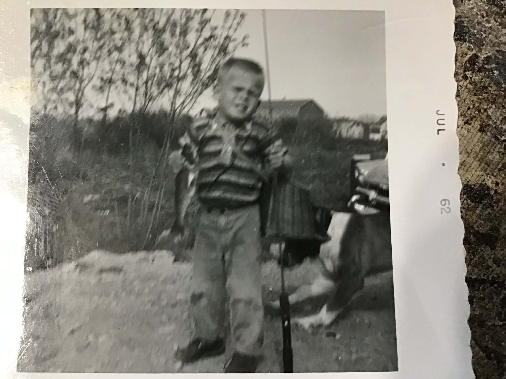 Before: old photograph of a boy with fishing gear